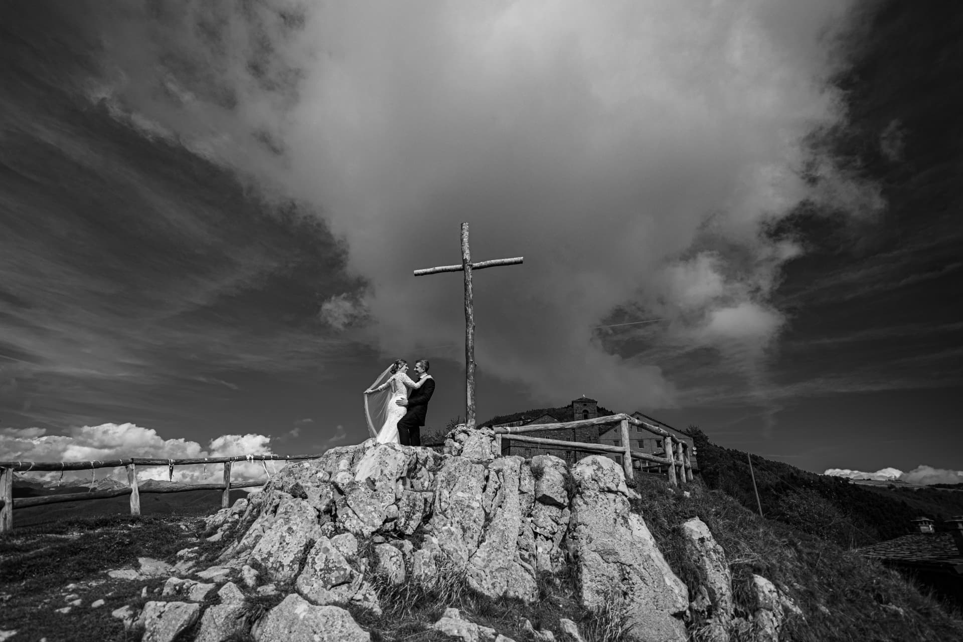 Gli sposi accanto alla croce di vetta, in bianco e nero